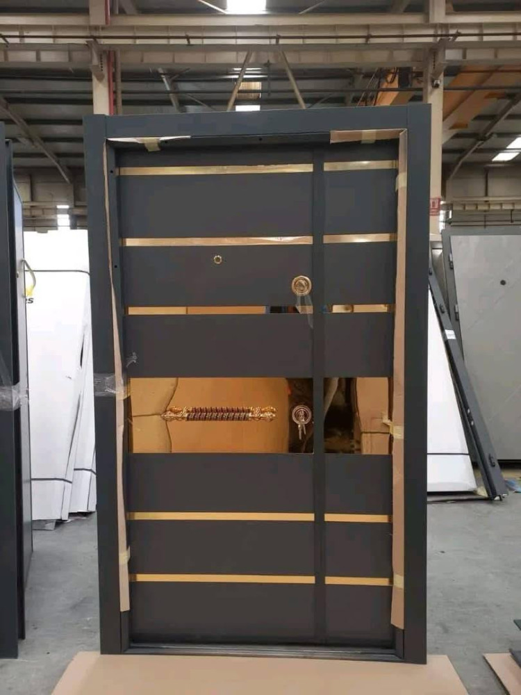 Modern Turkish Security Door with a dark finish and gold horizontal accents