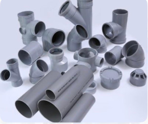 Assortment of PVC or CPVC pipes and fittings used for plumbing and drainage