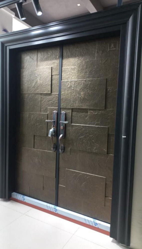 Bronze or gold-coloured steel Security Door with a textured stone-like finish and modern handles