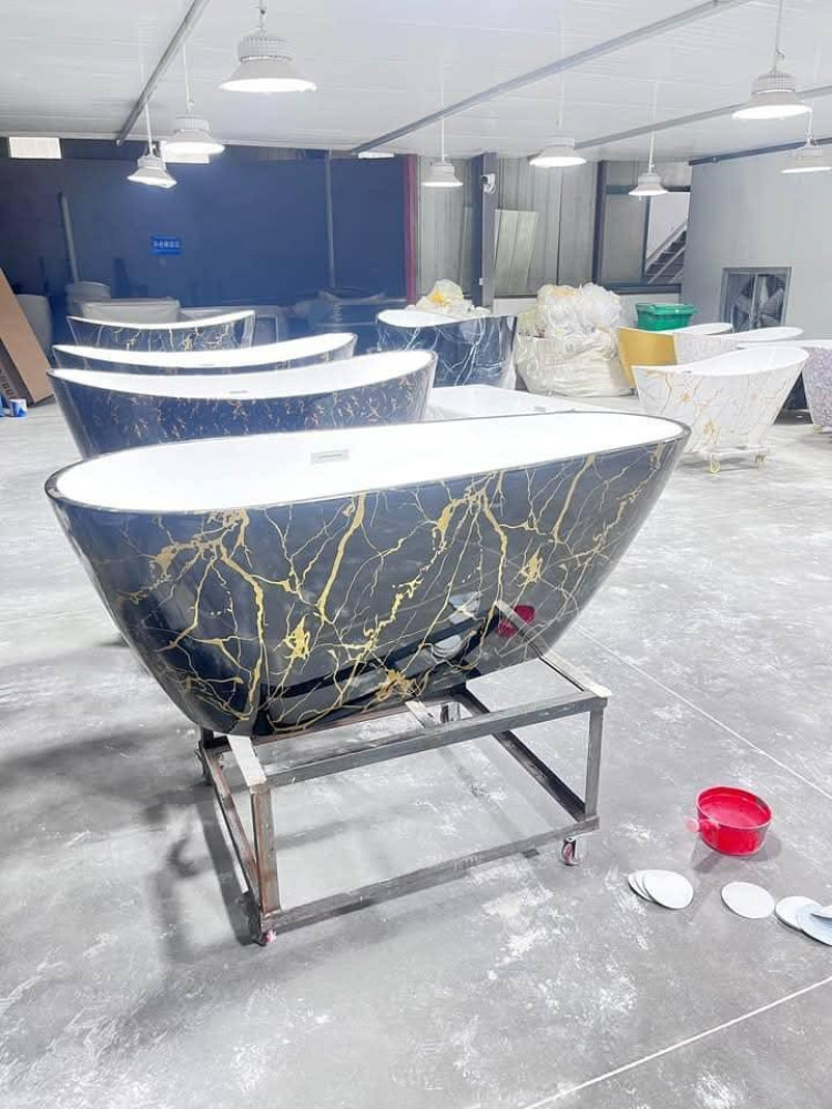 Freestanding Bathtu with a Black and gold marble Pattern