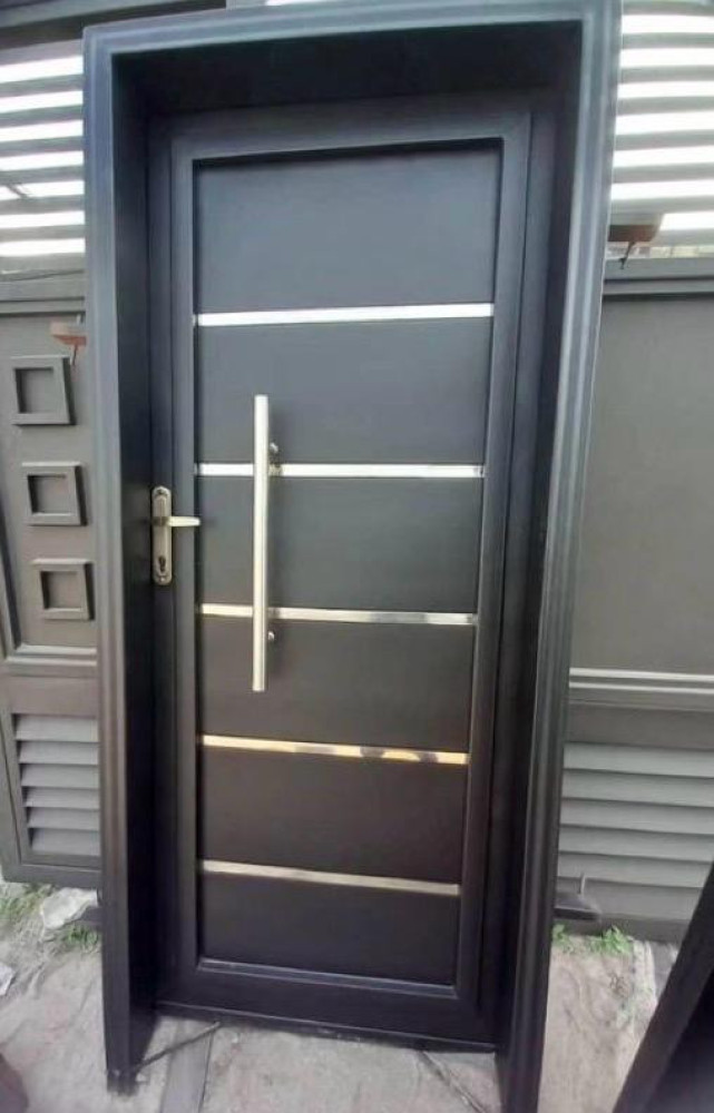Single Exterior metal or steel Door with horizontal stainless steel accent strips and a modern pull handle 