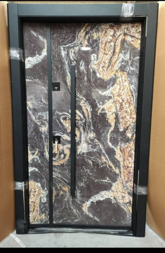 Modern Exterior Stone-finish door with ablack frame and a long pull hande