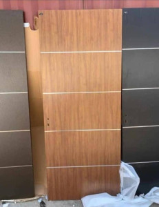 Original Turkish Flush Door with a light wood finish and horizontal metal inlays