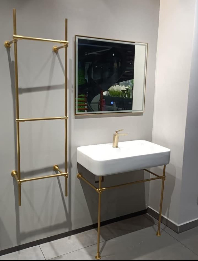 White Ceramic Console Sink with gold-finished Legs and matching towel rack