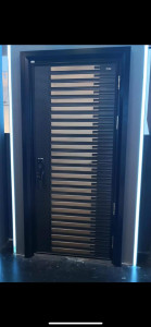 Steel Security Door with a black frame and horizontal gold-coloured panels