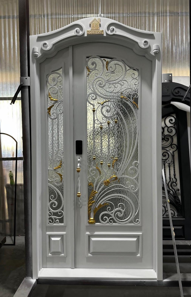 White wrought iron and glass security door with gold accents