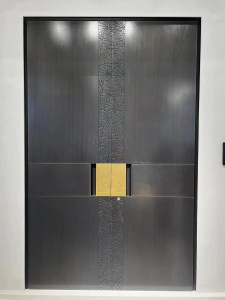 Modern metal security door featuring a laser-cut vertical pattern and a gold-toned handle section