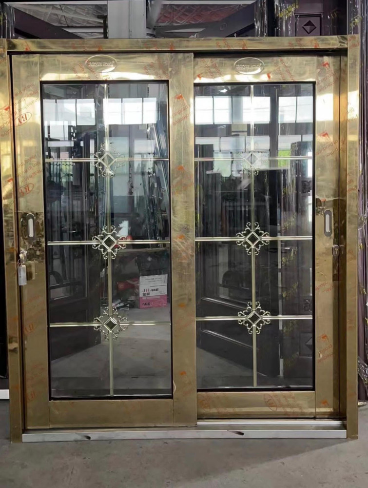 Gold-framed glass sliding door with decorative metalwork