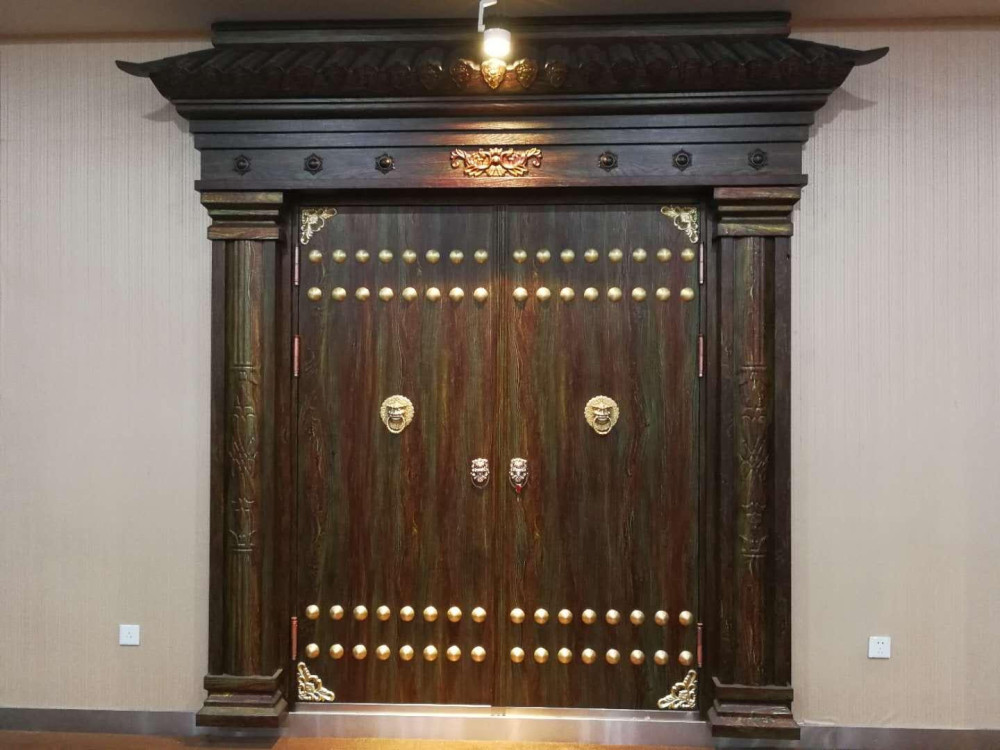 Highly Decorated main front Entrance Steel Double door with a traditional chinese-style wooden frame and header