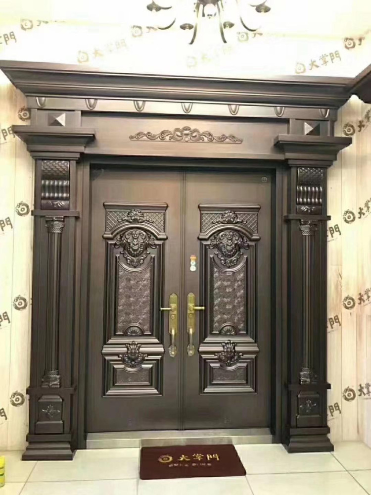 Ornate Double Entry Door with Decorative trim and gold-coloured hardware