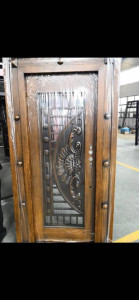 Steel Security Door with a wood-grain finish and decorative metal insert