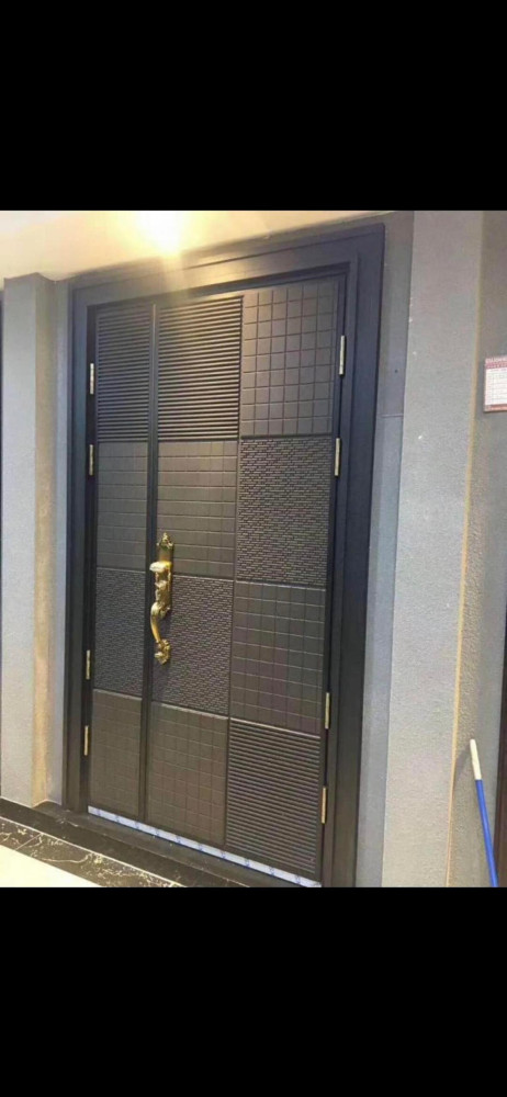 Modern Exterior Steel Security Door with a distinctive multi-textured panel design and vintage-style gold handle
