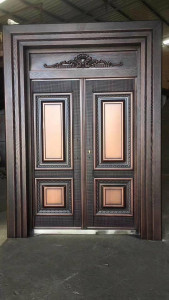 Double Security Door with a copper or similar finish and decorative molding
