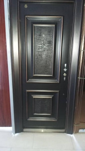 Steel Security Door with a black Finish and decorative bronze/copper 