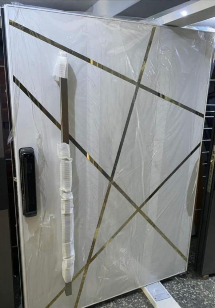 Modern Pivot Door with a White Finish and gold-tone geometric inlays