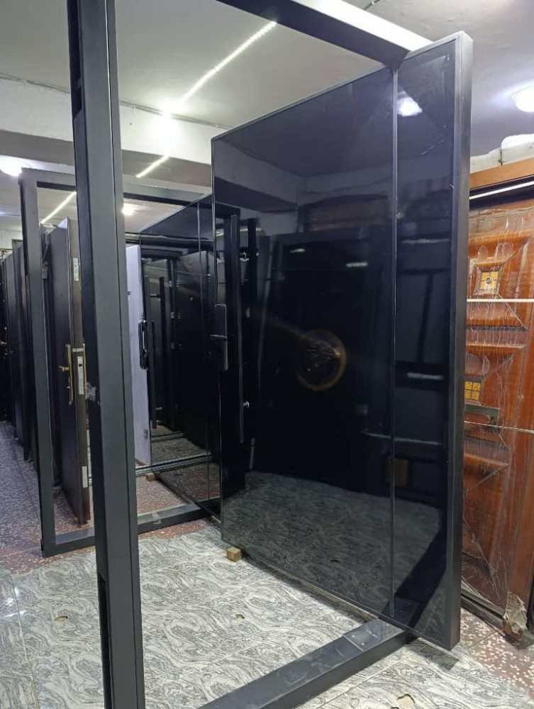 Modern Pivot Door with a glossy black finish and dark frame