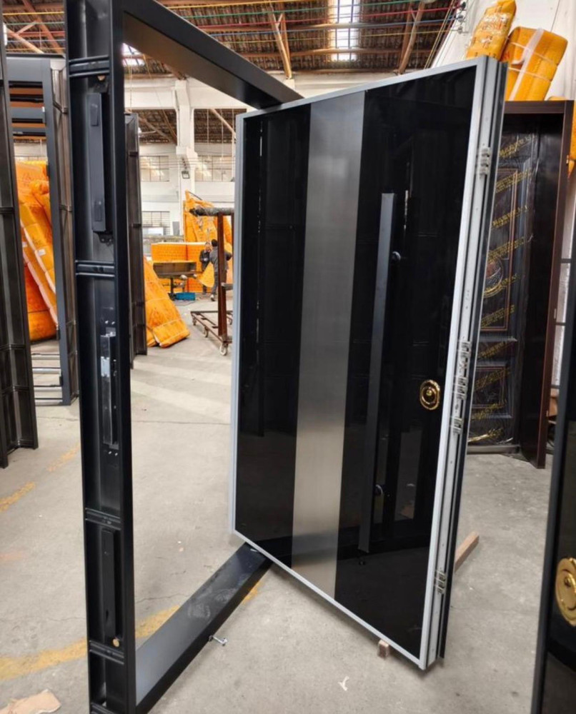 Modern Black and silver accent pivot door likely a security door