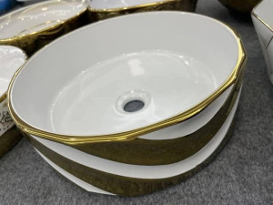 Modern white and gold oval ceramic bathroom vessel sink