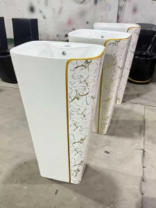 Modern ceramic floor-standing pedestal wash basin with a white and gold-plaited sythetic marble stone finish