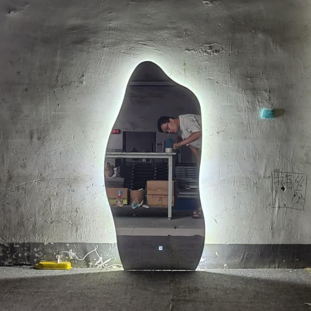 Modern frameless Led-backlit mirror with an organic irregular shape