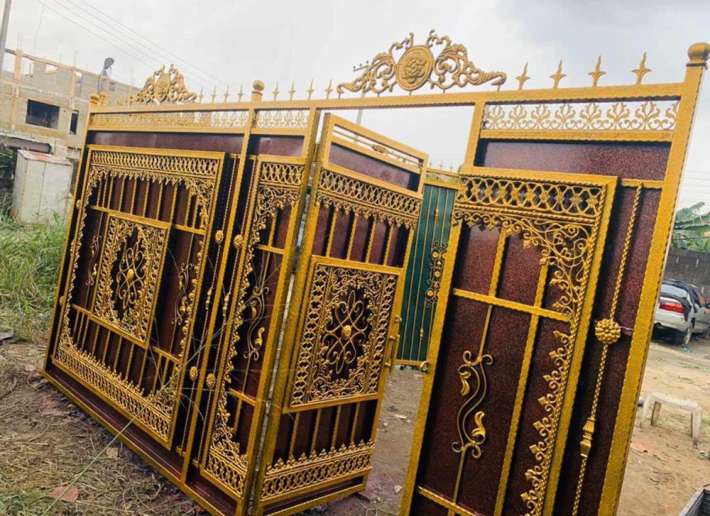 Ornate Wrought Iron gates featuring a luxurious brown and gold finish