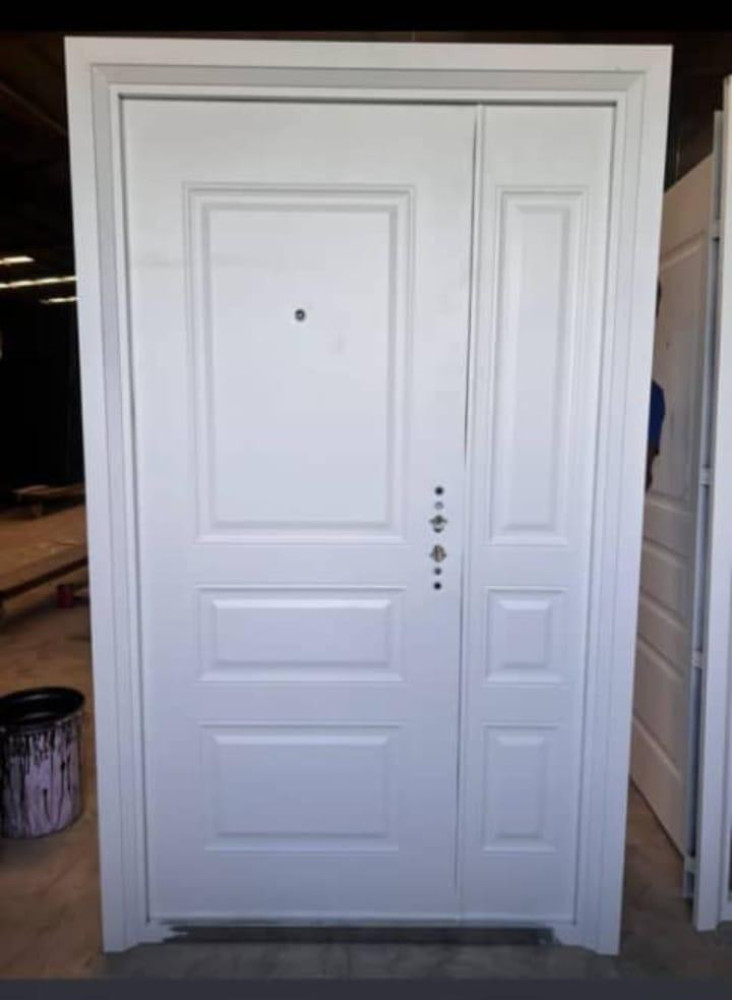 White powder-coated steel security door with a side panel