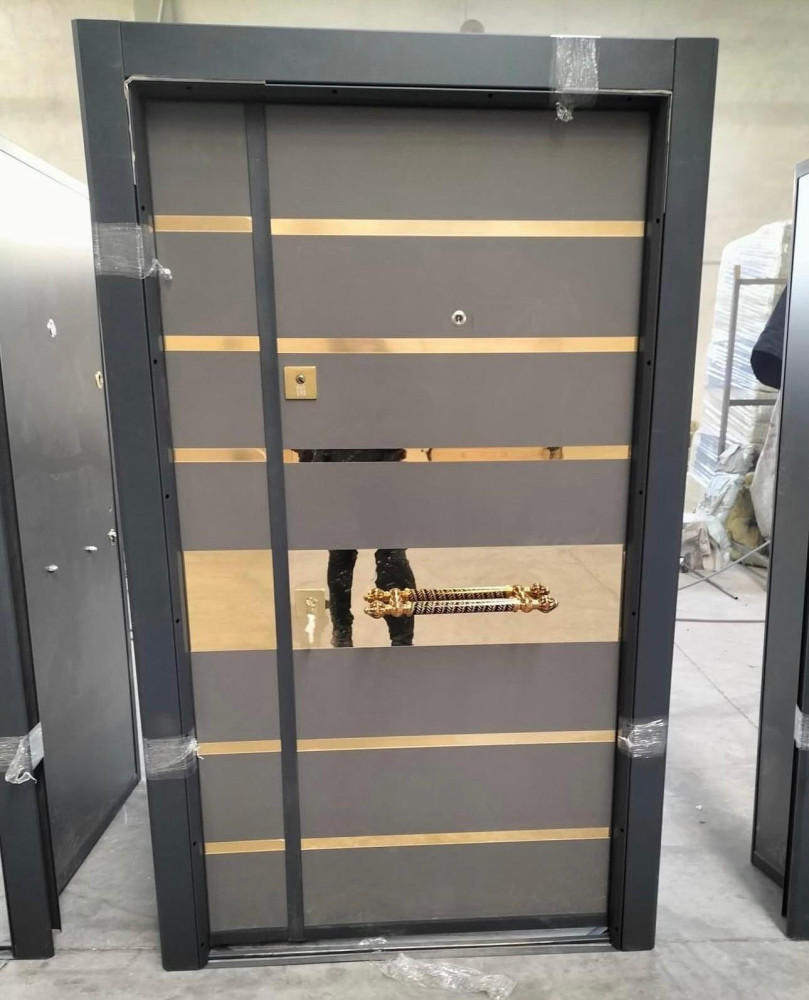 Turkish Security Door featuring gol-tone horizontal accents and a matching pull handle