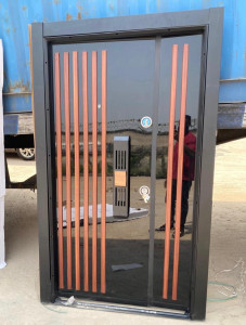 this is a modern turkish Security Dor with a high-gloss black finish and vertical wood-look accents