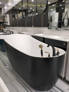 Black and White Freestanding French Bateau style Bathtub with a black and gold freestanding faucet